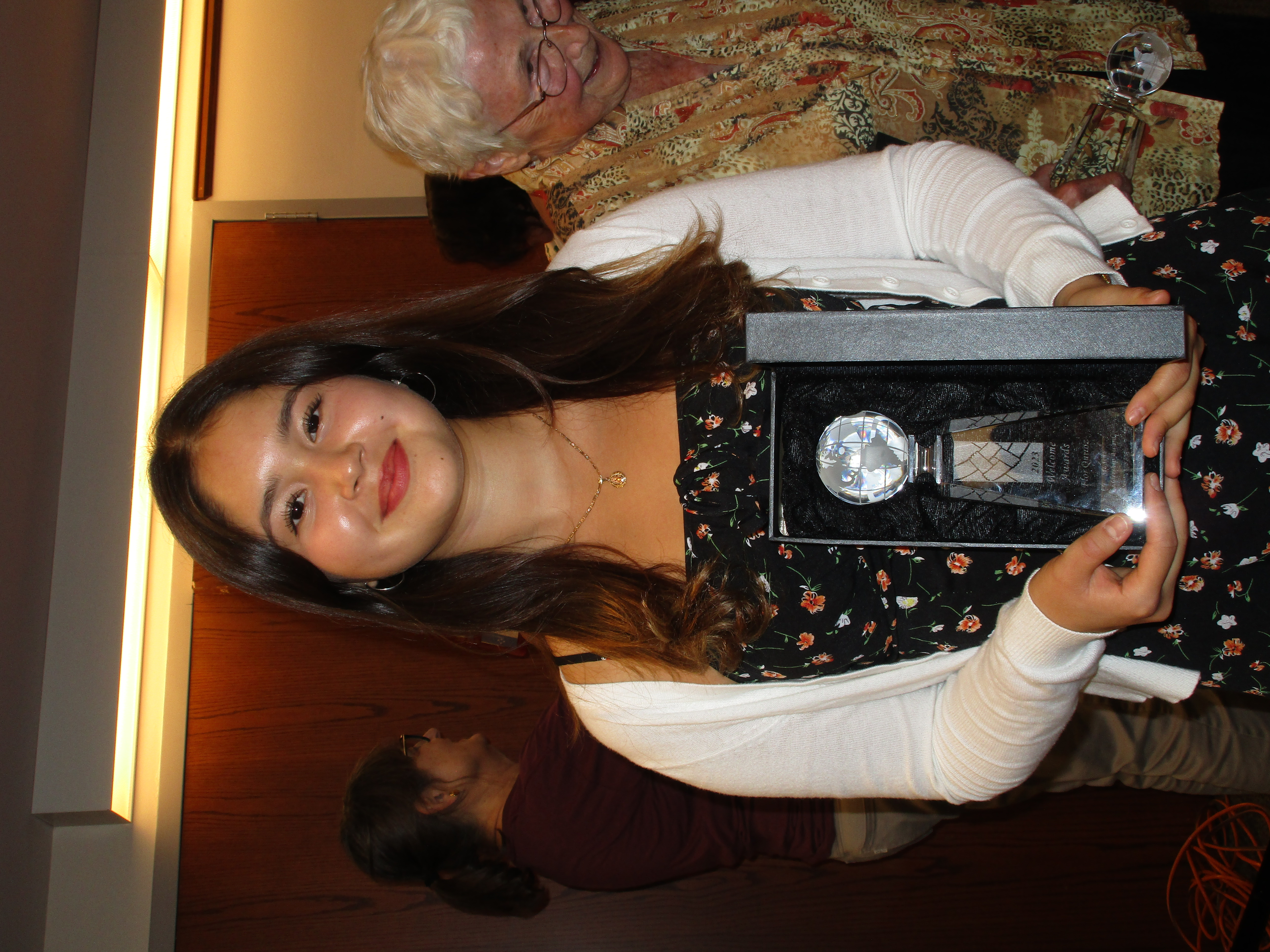 Flor Quiroz holds Student Leadership Award from C-U Immigration Forum